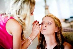 a woman having make up done