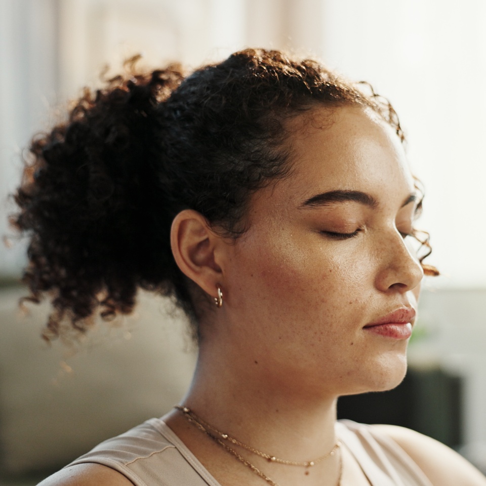 Woman, face and eyes closed with meditation in home for peace, calm and health for mindfulness. Female person, relax and zen with yoga as activity or hobby for stress relief, wellbeing and self care